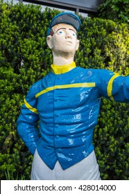 Yellow Stripe Metal Lawn Jockey With Blue Shirt