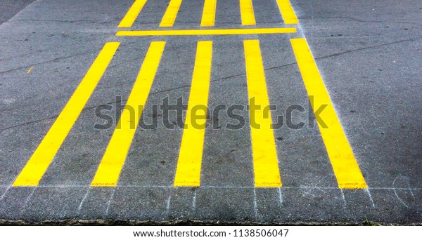 Yellow stripe\
printed on road, sign on\
road.
