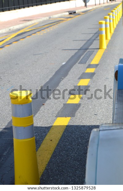 Yellow striped poles along the
road divide the direction of traffic, the concept of road
safety