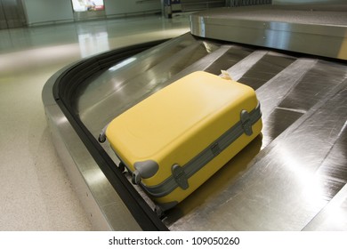 Yellow Suitcase On Airport Carousel