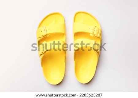 Yellow Summer Slippers, Rubber Slide Sandal on White Background, Vacation Concept, Top View, Flat Lay