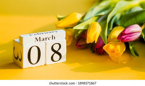 Yellow, sunny greeting card for Women's Day on March 8 with the number and month. Beautiful background of delicate tulips. March 8 and the concept of "Women's Day".
				