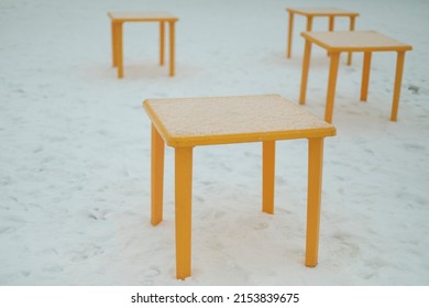 Yellow Tables. Plastic Tables For Eating Outside. Empty Tables In Winter.