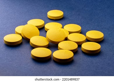 Yellow Tablets On Blue. Extasy Drug Bought On Dark Web Internet Online.