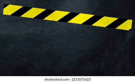 Yellow Tape With Black And Yellow Stripes On A Dark Background. Warning Ribbon.