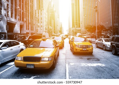 Yellow taxi in a Black and White New York in the sunset - Shutterstock ID 559730947