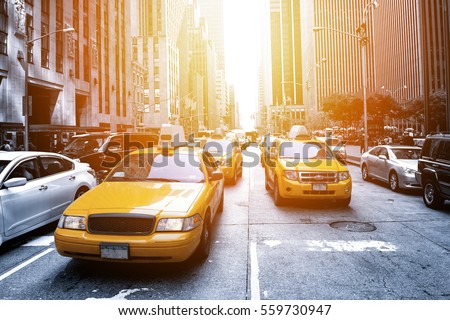 Yellow taxi in a Black and White New York in the sunset