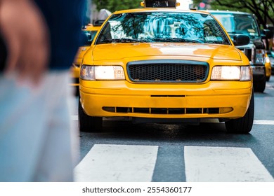 A yellow taxi cab drives through a city street, capturing the hustle and bustle of urban life, transportation, and cityscape dynamics. - Powered by Shutterstock