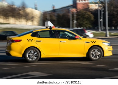 Yellow Taxi Cab In Motion On A Street