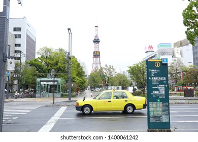 Yellow Taxi Cab Stop At Traffic Light With Zebra Cross For Pedestrian And Tv Tower Background: Hokkaido,Japan: May 8, 2019