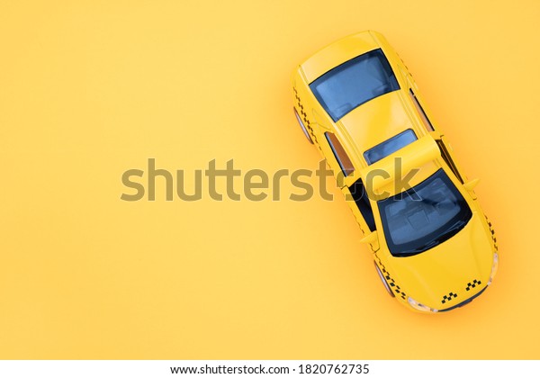 Yellow taxi car on\
a yellow background.\
Taxi