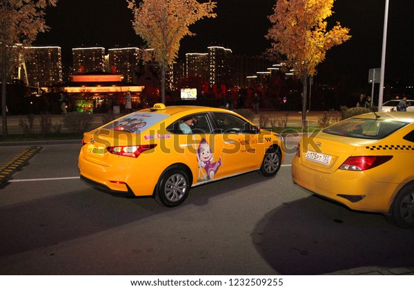 Yellow taxi car with a sticker from the\
cartoon \