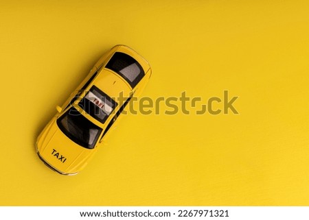 yellow taxi car - top view . Transport sign, auto, drive and symbol. yellow background. empty copy space for inscription.