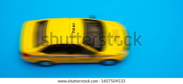 yellow\
taxi car - top view . Transport sign, auto, drive and symbol. blue\
background. empty copy space for inscription.\
