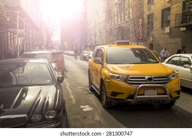 Yellow Taxi Crossing Small Street In Manhattan NYC