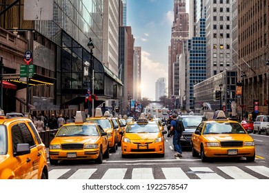 Yellow Taxi in Manhattan, New York City  in USA sunset - Powered by Shutterstock