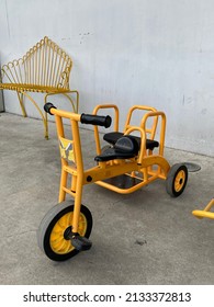 Yellow Taxi Trike For Kids. Yellow Tricycles In A Backyard. Children's Three-wheeled Bicycle Yellow. Out On The Floor. Close-up. Kid's Bike. Toy. Nostalgia Concept. Childhood.