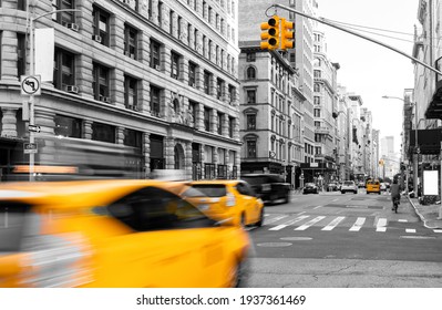 Yellow taxis driving in black and white street scene on Fifth Avenue in Manhattan New York City NYC