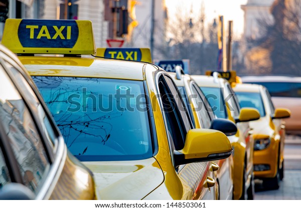 yellow taxis are standing in\
line 