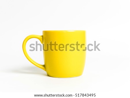 Yellow tea cup isolated on white.