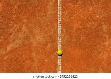  A yellow tennis ball lies on the clay court. Big panorama. - Powered by Shutterstock