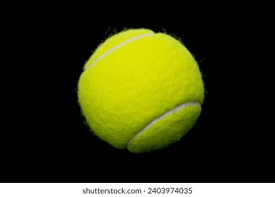 Yellow tennis ball on a black background. - Powered by Shutterstock