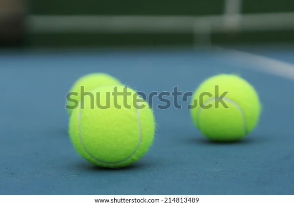 Yellow Tennis ball on the\
blue court