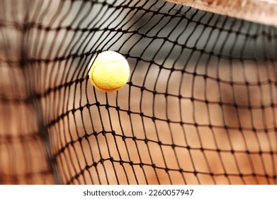 yellow tennis ball on net
