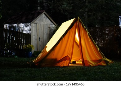 Yellow tent on the green grass in the backyard - Powered by Shutterstock