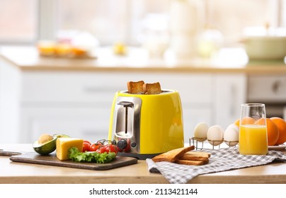 Yellow Toaster With Healthy Food On Table In Light Kitchen