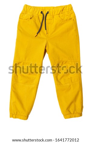 Yellow toddler-boy pants isolated on white background for spring and autumn wardrobe/ Сhildren's wear/ Close-up/ Flay lay/ Top view