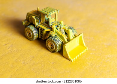 Yellow Toy Bulldozer On Yellow Background