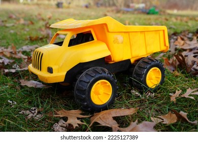 Yellow Toy Dump Truck Sits Outside