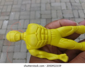 Yellow Toy Robot With Missing Arm