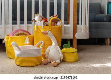 Yellow Toy Storage Baskets In The Children's Room. Cloth Stylish Baskets With Toys. Organizing And Storage Ideas In Nursery. Clean Up Toys And  Reduce The Clutter.