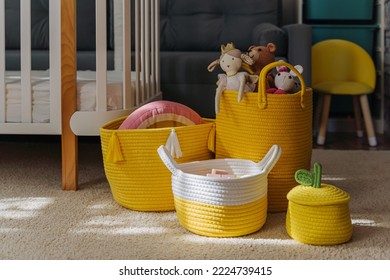 Yellow Toy Storage Baskets In The Children's Room. Cloth Stylish Baskets With Toys. Organizing And Storage Ideas In Nursery. Clean Up Toys And  Reduce The Clutter.