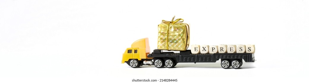 Yellow Toy Truck With Flatbed, Golden Gift Box And Express Lettering. Concept Of Fast Express Delivery,  Concept Of Transportation Goods.  Copy Space. Web Banner. White Background