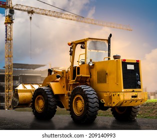 Yellow Tractor On The Road At Construction Site