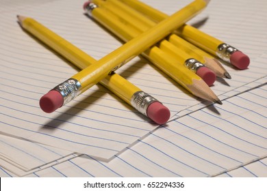 Yellow Traditional Pencils Closeup On Notebook Paper