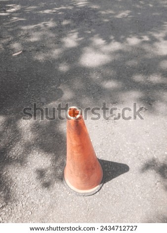 Yellow traffic cones stand sentinel along the roadside, guiding and cautioning travelers with their vibrant hue. These sturdy cones, coated in a bright yellow finish, command attention amidst
