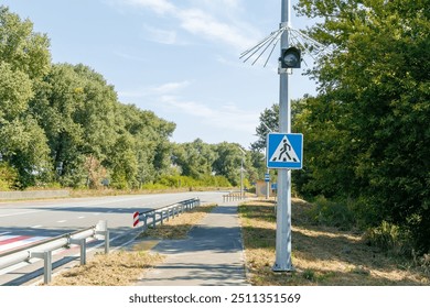 A yellow traffic light is flashing against a clear sky. Countdown timer. Unregulated pedestrian crossing equipped with flashing yellow traffic lights that work on solar batteries - Powered by Shutterstock