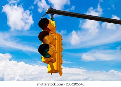 Yellow Traffic Light On Green Against Clear Blue Sky In New York City, NY, USA