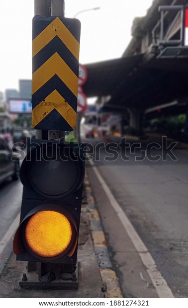 yellow traffic light and\
street sign
