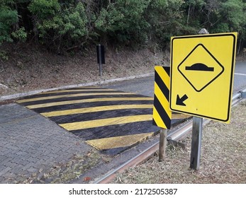 Yellow traffic sign indicating speed bump, traffic safety.