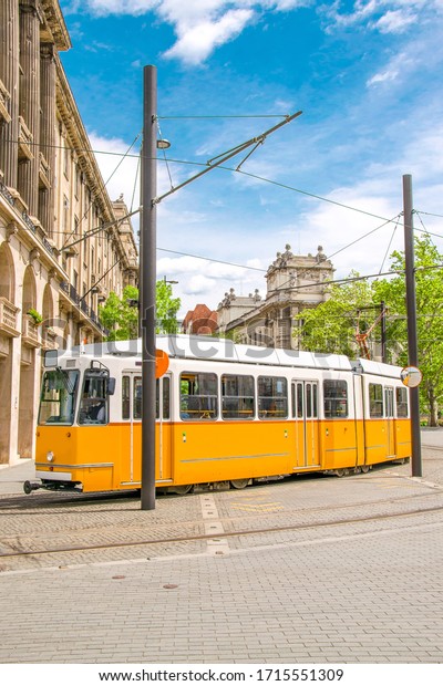 Yellow tram in Budapest - Public transport\
in Hungary. Old streets of capital\
city