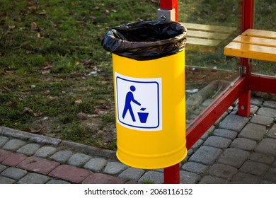 Yellow Trash Can At The Bus Stop