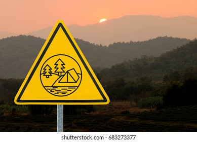Yellow triangle warning sign, warning sign, lable, Yellow warning sign, Yellow sign Camping tent area, Camping at the forest,campground on the mountain background
