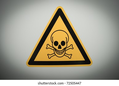 Yellow triangular danger sign with black skull