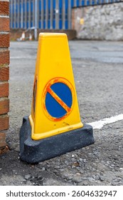 Yellow Triangular No Waiting Traffic Cone with Heavy Rubber Base for Unauthorised Parking Control Next to  Property Entrance