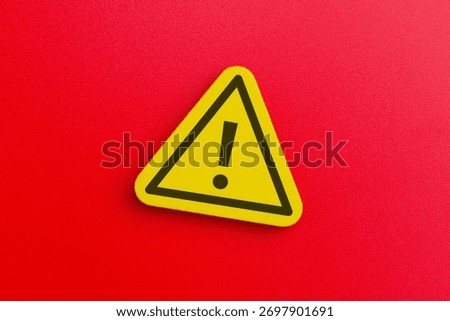 A yellow triangular warning sign with an exclamation mark. Danger, alert, caution, and safety warning concept.